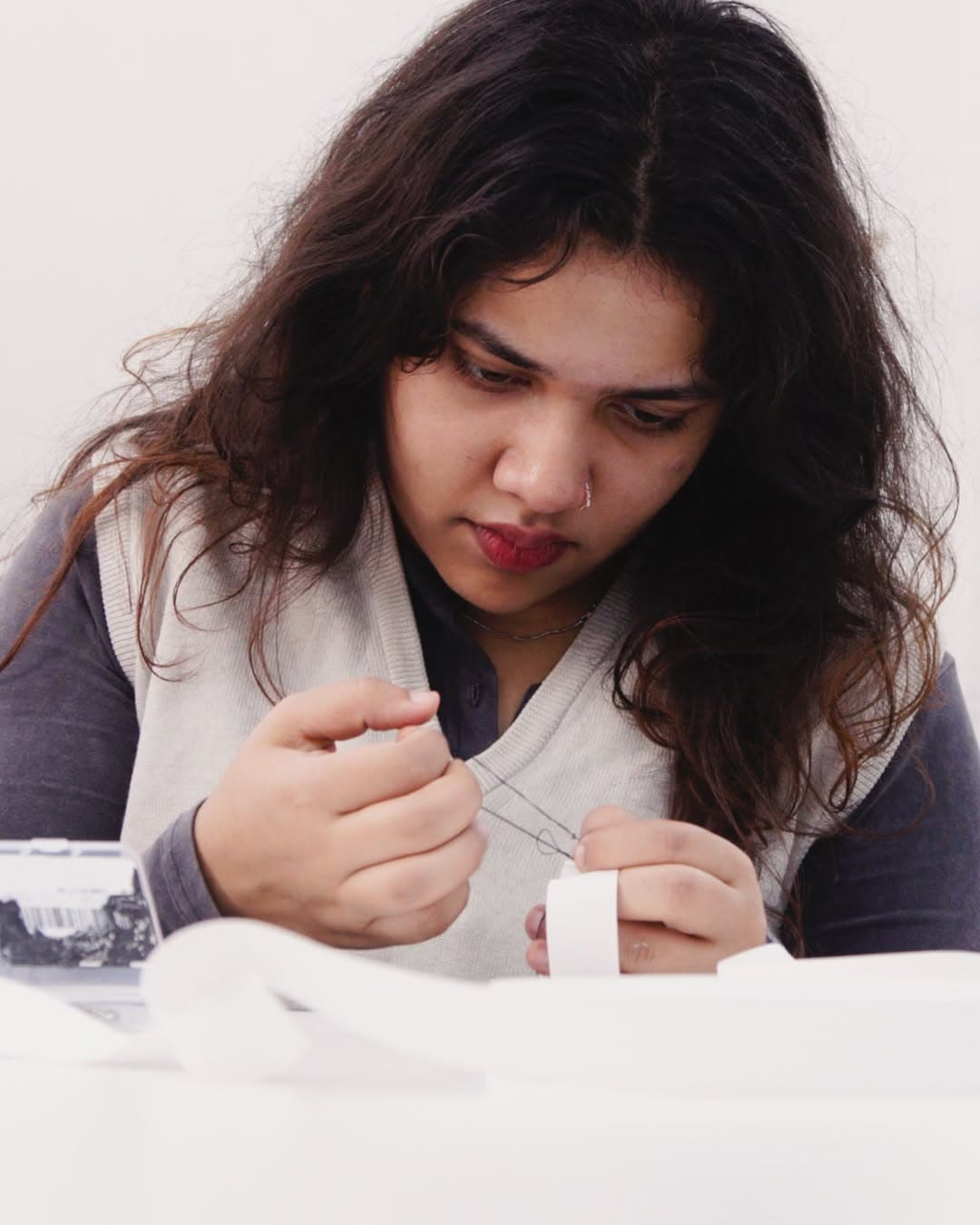 Fiza Riyas hand-stitching in the studio